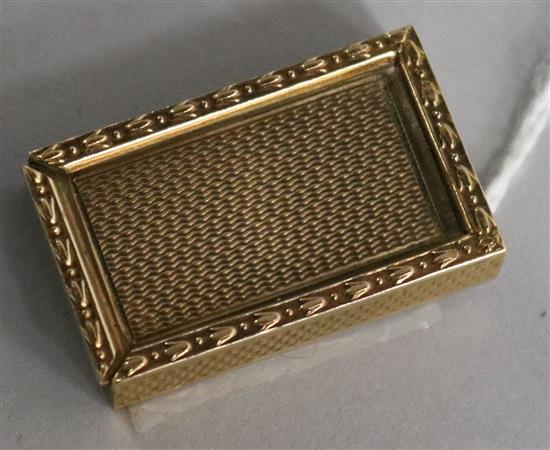 A 1960s 9ct gold engine-turned rectangular patch box, with harebell and bead edging and sliding cover, 15.7gms, 32mm.